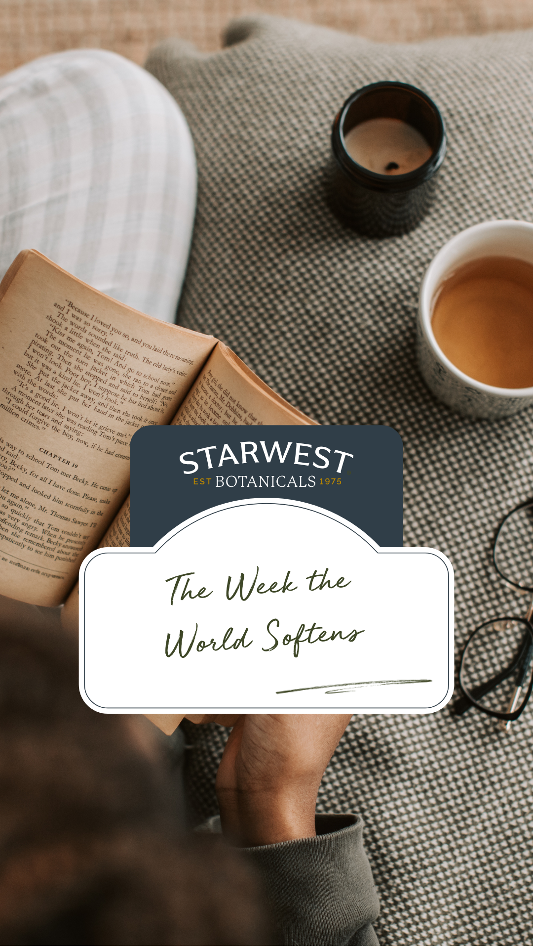 A picture of someone reading a book and enjoying a hot cup of tea